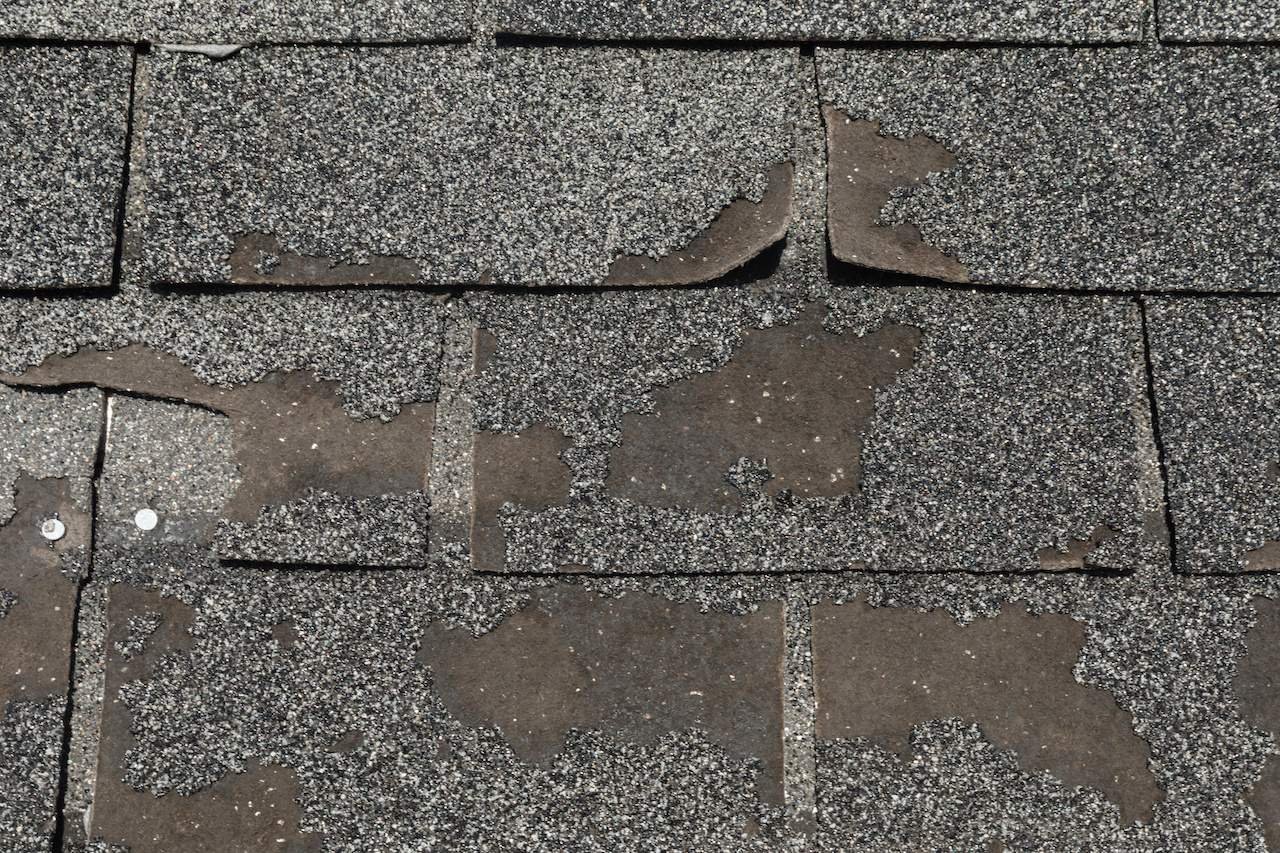 Granular loss on aging asphalt shingles in Oklahoma City that can increase roof repair cost and make material matching harder